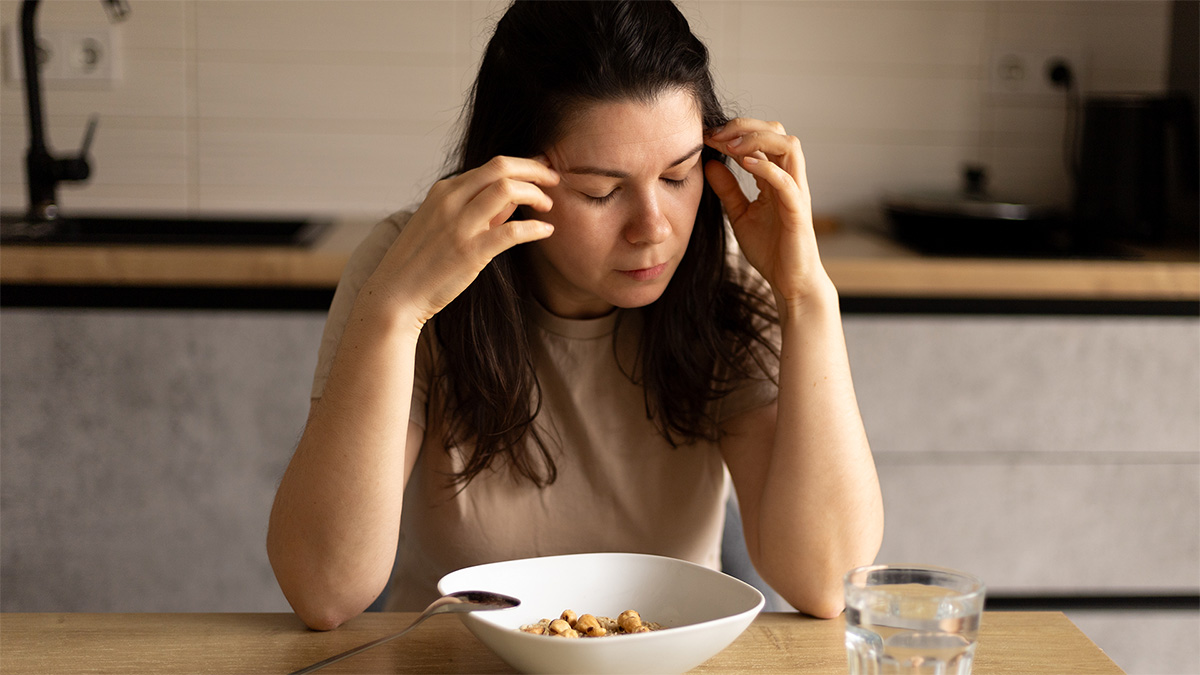 Sad woman holding her head in her hands